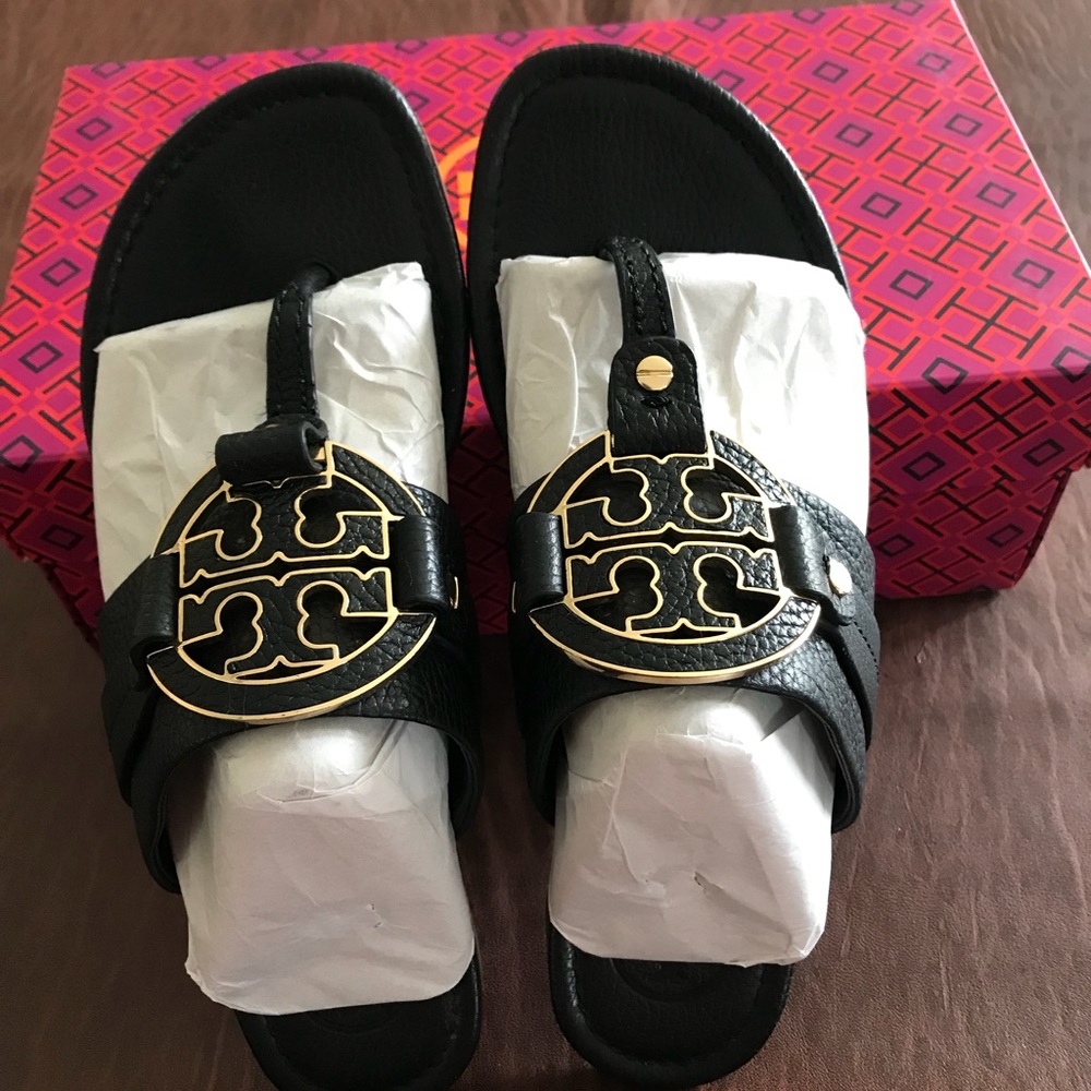 Tory Burch black pebble leather with gold emblem.